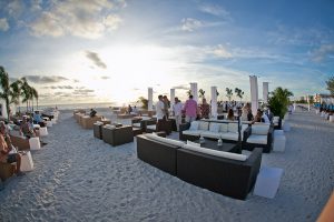 Luxury beach lounge furniture rental setup for Florida waterfront event